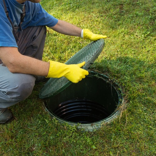 Plumber Opens Septic Tank for Cleaning.
