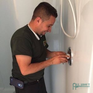 A Picture of a Man Fixing a Shower Handle