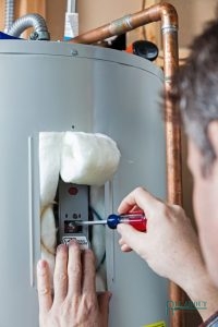 A Plumber Repairing a Water Heater