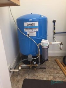A Picture of a Well Water Tank with a Whole House Water Filter Attached