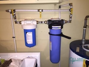 A Whole House Filtration System Installed in a Laundry Room